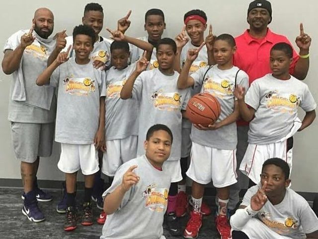 Domination youth team celebrating with coaches in championship shirts