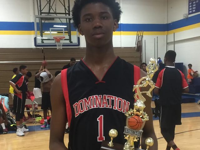 Domination player holding a tournament championship trophy